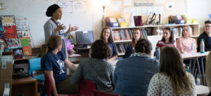 Suad standing in front of group of global minds students